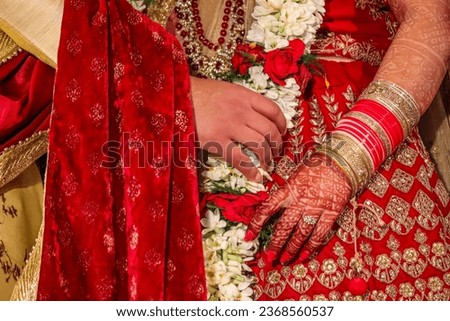 picture of groom and bride hands during ver Mala ritual of marriage ceremony