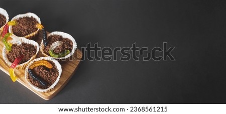 Halloween wormy dirt cupcakes, banner with copy space. Holiday food, selective focus Royalty-Free Stock Photo #2368561215
