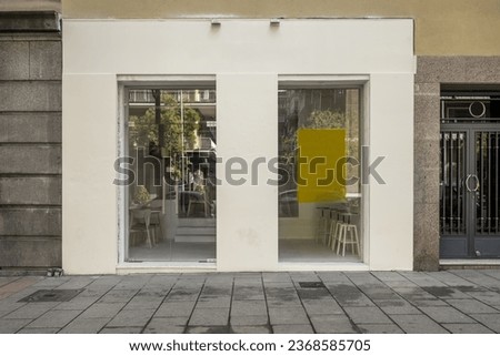 Commercial premises at street level with light painted walls and large rectangular windows