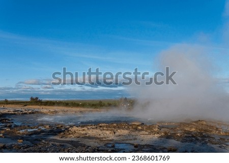 Strokkur, a fountain-type geyser located in a geothermal area beside the Hvítá River, southwestern Iceland, east of Reykjavík. It typically erupts every 6–10 minutes. Part of The Golden Circle Tour. Royalty-Free Stock Photo #2368601769