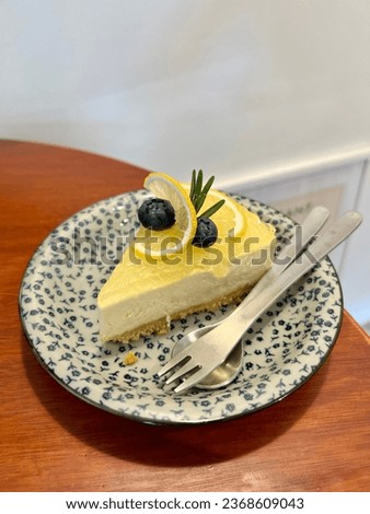 A piece of Lemon cake topped with fresh blueberry.