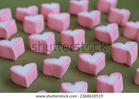 heart shape marshmallows on wooden background, on table for love and valentine's day.