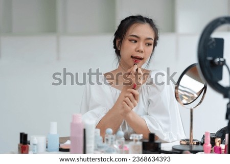 Asian beauty businesswoman live streaming makeup tutorial video clip Live selling cosmetics Perfume by camera sharing on social media, social media concept online sales online shopping.