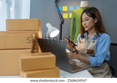 Small business start up, SME owner, female entrepreneur working on packaging parcel boxes, call, confirm order and verify online orders to prepare boxes for customers. SME business concept.
