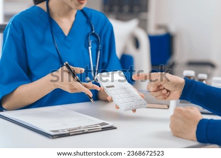 Cost of medical care, calculator, Asian people experienced female doctor giving advice to elderly male patient cancer and x-ray results and treatment options, Cancer Consultation