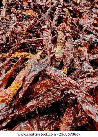 Closed up picture of a pile of dried chilies on the table in vertical format.