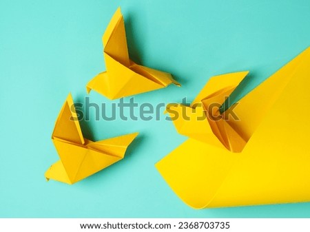 OIrigami doves on a blue yellow background. Creative layout. Top view