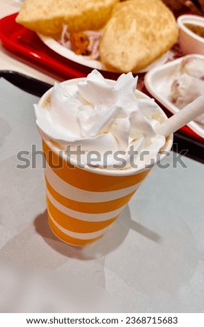 creamy drink in orange cup