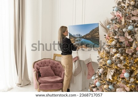 Female holds canvas, Christmas concept. White canvas board and Christmas decoration.