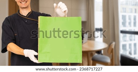 Courier holding paper bags with food, space for text. Delivery service
