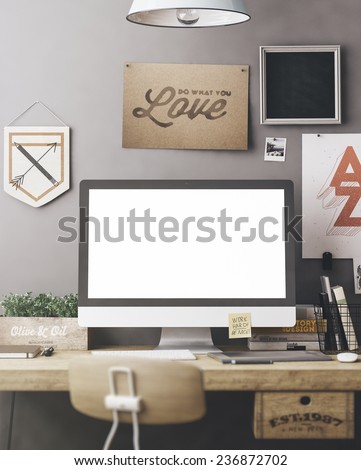 Stylish workspace with computer and posters on home or studio