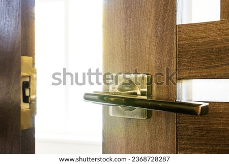 Abstract photograph of an open door. A slightly open door through which you can see the light from the window.