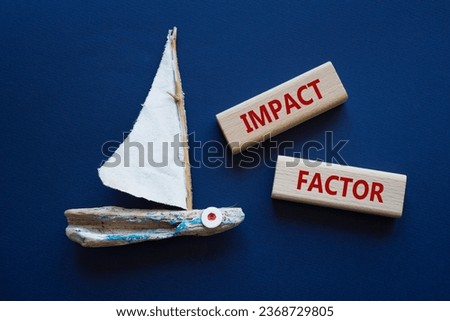 Impact Factor symbol. Wooden blocks with words Impact Factor. Beautiful deep blue background with boat. Business and Impact Factor concept. Copy space.
