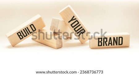 BUILD YOUR BRAND symbol of your brand on a wooden block. BYB Concept Words. Copy space.