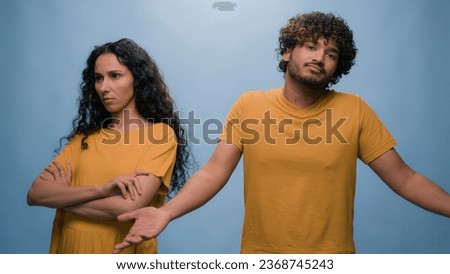 Family problem couple divorce breakup Indian man husband asking forgiveness to offended wife Latino woman apologizing for misunderstanding feeling guilty saying sorry apology at studio blue background