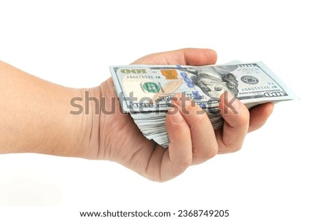 holding a wad of $100 bills