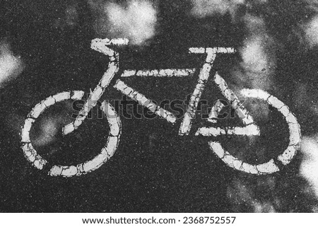 A bike path sign is painted on the asphalt. Bicycle as a sign on the road