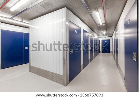 Corridor of self storage units with blue doors. Rental Storage Units Royalty-Free Stock Photo #2368757893