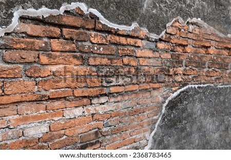 Photo of an ancient wall with repairs and cracks.