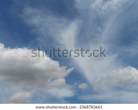a plane flying through a cloudy blue sky, visible sky and humid atmosphere, cirrus clouds, partly cloudy sky, altostratus clouds, wispy clouds, wispy clouds in a blue sky, atmospheric environment, air