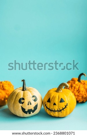 Beautiful jack o lantern pumpkin on a blue background.Creative halloween concept backdrop.Kids halloween pumpkin craft.
