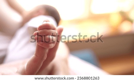 mother holding baby newborn hand. friendly family kid dream concept. mothers day concept. baby newborn in mother arms close-up hand lifestyle Royalty-Free Stock Photo #2368801263
