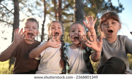 a group of children shouting and rejoicing in forest park. happy family child dream concept. A group of children in a pioneer camp are playing shouting having lifestyle fun playing around