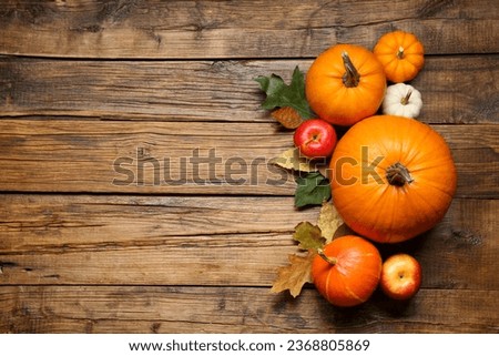 Thanksgiving day. Flat lay composition with pumpkins on wooden table, space for text