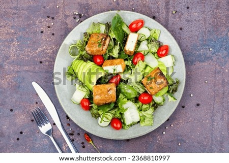 Unusual salad with fried halloumi cheese, vegetables and herbs Royalty-Free Stock Photo #2368810997