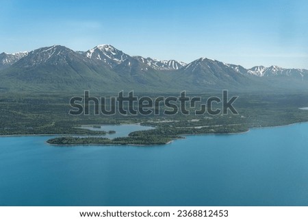 Aerial view of Port Alsworth, Alaska within Lake Clark National Park and Preserve. Private Port Alsworth Airport, public Wilder Natwick Airport, Tanalian Mountain, Chig­mit Mountains, Hardenburg bay. Royalty-Free Stock Photo #2368812453