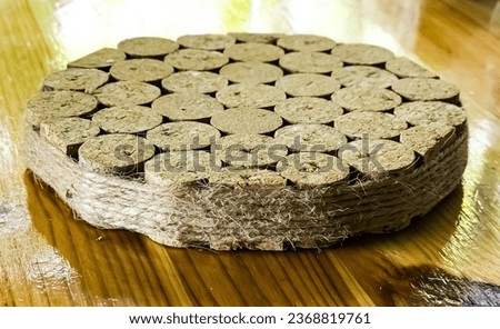 A stand for hot objects made from wine corks. Kitchen items. Royalty-Free Stock Photo #2368819761