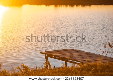 Wooden pier, bridge on the river. Autumn, sunset. atmospheric photography