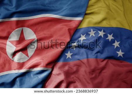 big waving realistic national colorful flag of north korea and national flag of venezuela . macro