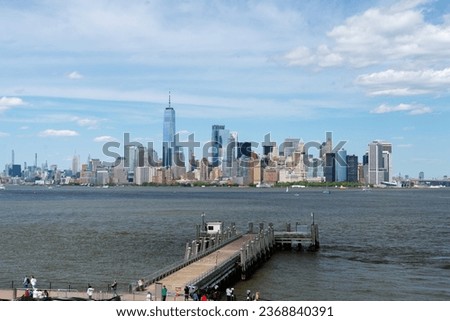 lower manhattan from the statue of liberty and in the foreground a wooden pier