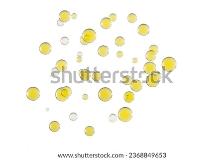 Yellow and clear bubbles mixed together over a white background.