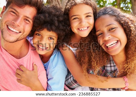 Parents Giving Children Piggyback Ride Outdoors Royalty-Free Stock Photo #236885527