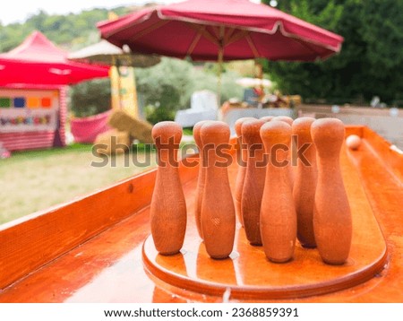 Bowling pins made of wood in the festival area.