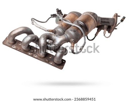 Automotive catalyst removed from a vehicle for repair with a ceramic coating inside as part of an exhaust system to remove harmful emissions in a car repair shop Royalty-Free Stock Photo #2368859451