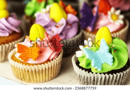 A picture of a cupcake decorated with colorful buttercream