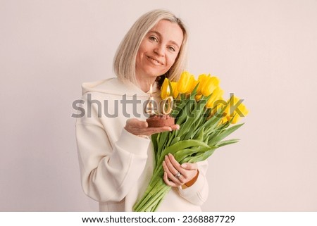 Birthday, 40 years old, happy woman with bouquet of flowers and cake