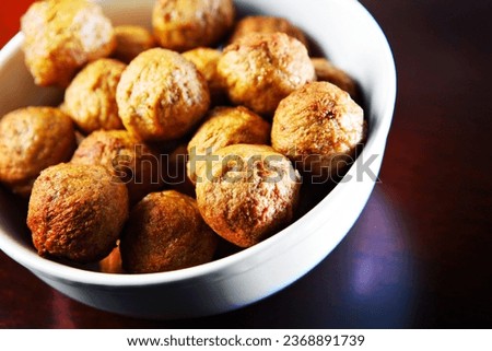 A picture of a bowl full of traditional Swedish meatballs