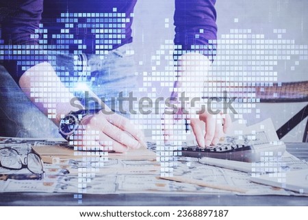 Double exposure of Man writing in notepad with business icons on background. Concept of international business.