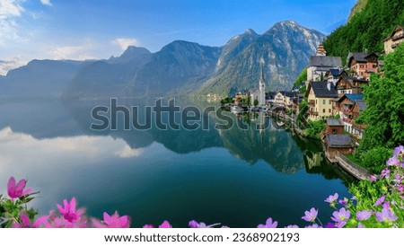 Hallstatt, Austria; September 30, 2023 - Scenic picture-postcard view of famous Hallstatt village reflecting in Hallstattersee lake in the Austrian Alps in beautiful morning light.