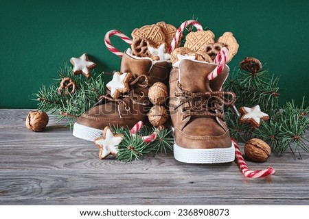 Saint Nicholas Day or Nikolaus, german holiday, December 6. Children shoes with traditional sweets. Royalty-Free Stock Photo #2368908073