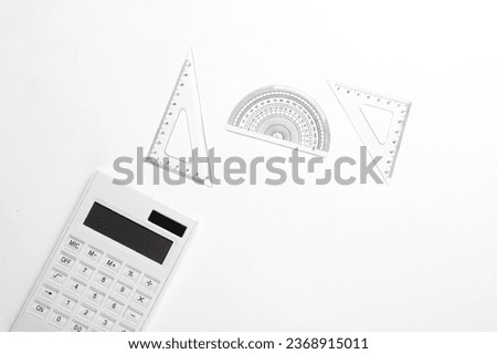 Calculator and ruler set on white background. Back to school, mathematics, exact sciences