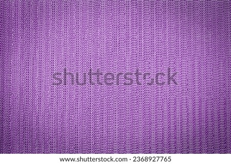 Abstract lavender colored mesh fabric background with vignette top view, macro photography.