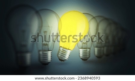 Row of extinguished light bulbs and one glowing yellow light bulb, creative idea. Individual approach and success, concept. Brainstorm and creative idea Royalty-Free Stock Photo #2368940593