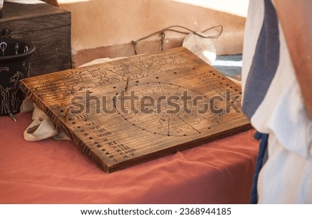Reenactor reading annual roman calendar and zodiac. Divination methods in ancient rome