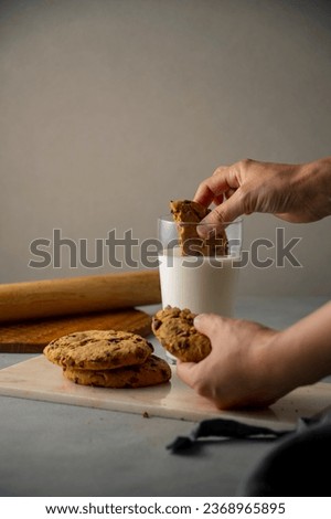 Dip a chocolate chip cookie in milk.
Sweet chocolate chip cookie picture.