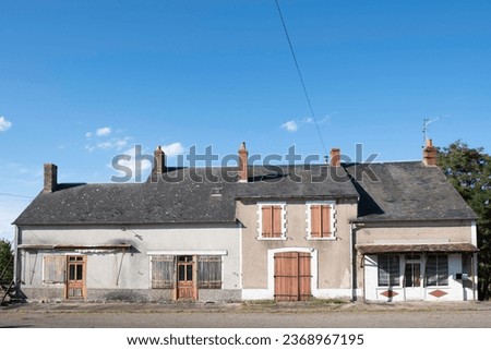 Old dilapidated houses in a French hamlet. The countryside in France is emptying, the houses are falling into disrepair and becoming uninhabitable Royalty-Free Stock Photo #2368967195
